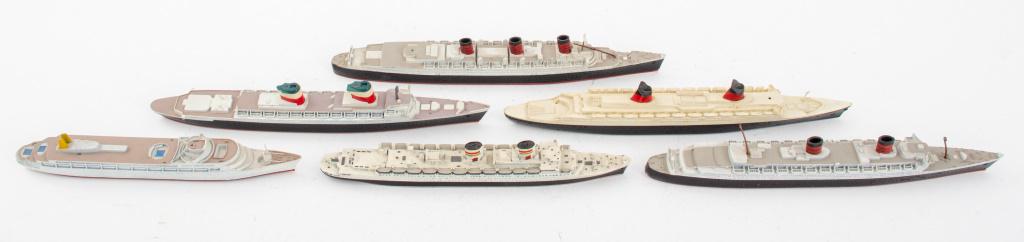 Vintage Toy Ship Models, 6: Vintage toy ship models of the Queen Mary, the Queen Elizabeth, Mercator Rex (bottom lacking) United States, France, and Caberra, some painted metal with resin bases and wheels, some marked "Made in H