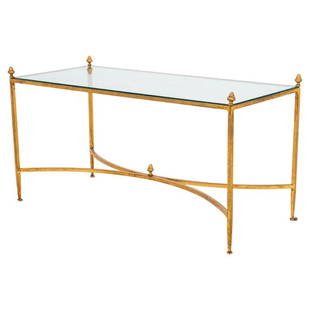 Maison Ramsay Style Gilt Coffee Table: Maison Ramsay style gilt low table, with rectangular glass top above four finialed tapering columnar supports conjoined by curved stretchers. 19" H x 36" W x 16" D Provenance: Property from the Estate