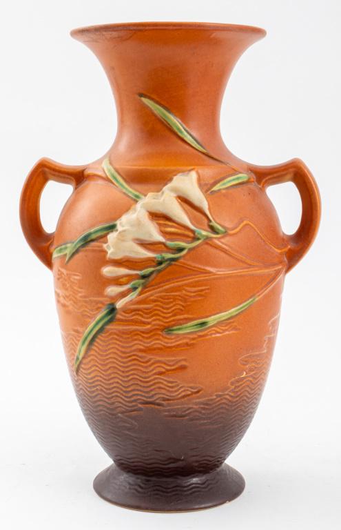 Roseville Pottery "Freesia" 12" Vase: Roseville Art Pottery "Freesia" vase, with "Roseville U.S.A." mark to underside with model number "127-12", and with yellow and orange decoration, circa 1945. 12" H x 8" W x 6.5" D.