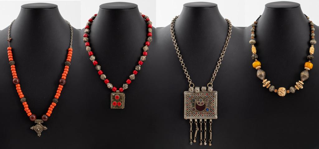 North African or Middle Eastern Necklaces, 4: Group jewelry lot of four antique and vintage North African or Middle Eastern tribal necklaces, two with red coral beads, one with carved bone skull and geometric beads, and one Afghan Kuchi box neckl