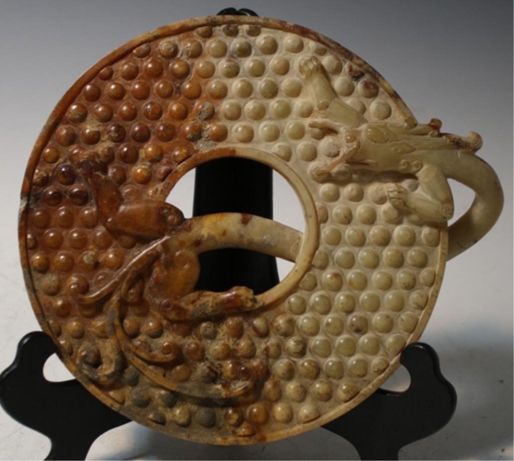 Chinese Carved White Jade Bi Disk w/ Dragon: Carved white jade bi disk with dragon, China; unmarked. Dimensions: 10-3/4"H x 9-1/4"W x 1-1/2"D