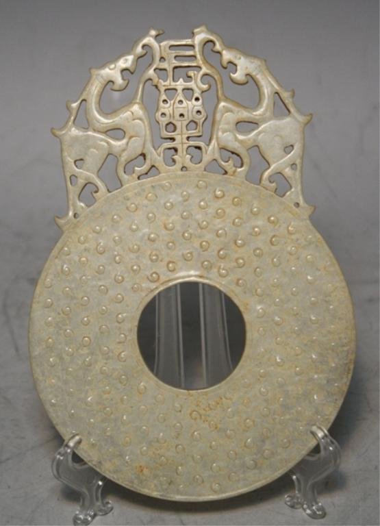 Chinese Carved White Jade Bi Disk w/ Two Dragons: Carved white jade bi disk with two dragons, China; unmarked. Dimensions: 7-1/2"H x 5-1/4"W x 1/4"D