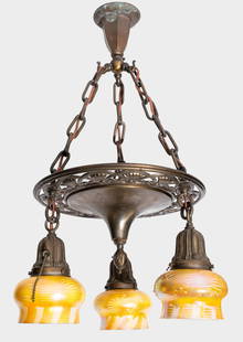 Art Nouveau Brass 3-Arm Quezal-Shaded Chandelier: Art Nouveau patinated brass chandelier with three lights mounted with mottled and swirling iridescent favrile Quezal glass shades, all marked "Quezal". 32" H x 12.5" diameter; shades: 3.5" H x 4.5" di