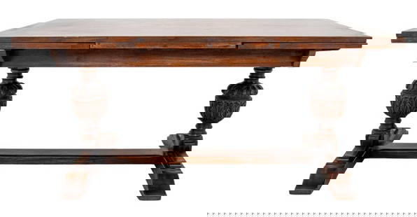 Tudor Revival Oak Dining Table: Tudor Revival carved oak wood dining table with two acanthus leaf design urn-form supports, with two leaves. Closed: 30.5" H x 66" W x 38" D. Provenance: Property from a 239 Central Park West estate.