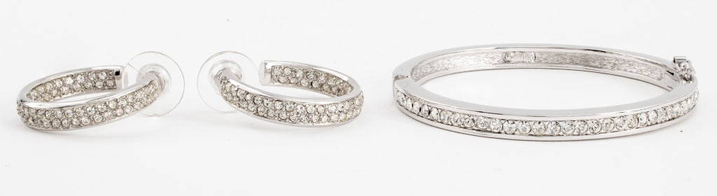 Christian Dior Gem-Set Earrings & Bracelet: Christian Dior silver-tone metal jewelry set with inset crystal gemstones comprising one bracelet and a pair of hoop earrings, each marked. Bracelet: 2.5" L x 2.25" W.