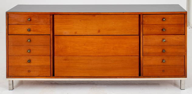 Midcentury Modern Mahogany Dresser: Mid-Century Modern mahogany wood dresser, the rectangular top above three centered long drawers, flanked by five short drawers with patinated metal pulls above a chrome strip and chrome-clad block fee