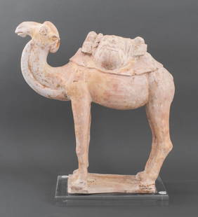 Chinese Tang Dynasty Ceramic Camel Tomb Figure: Ancient Chinese, Tang Dynasty (618-906 C.E.), ceramic pottery tomb sculpture depicting a camel figure wearing a saddle with bags in the form of animal head masks, the statue standing upon a rectangula