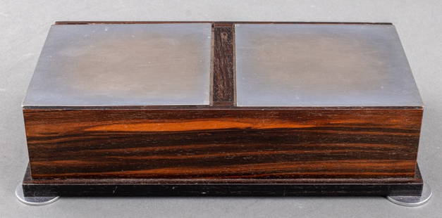 Art Deco Chrome & Macassar Wood Table Box: Art Deco period macassar wood table box with ebonized wood border and two chrome metal hinged lids and four disc feet. 2.5" H x 10.25" W x 5.5" W. Provenance: From a Rye, N.Y. collection.