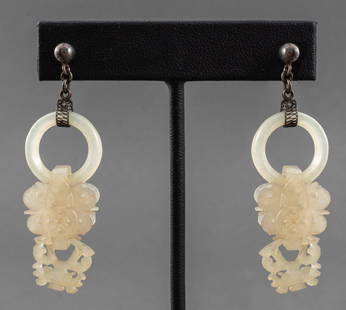 Chinese Carved White Jade Silver Earrings: Chinese pair of earrings with carved round jade hoops suspended by two articulated pierced white jade drop pendants and silver post backs, the jade carvings likely Qing Dynasty (1636-1912). 2.5" L x 1