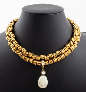 Vintage Chanel Faux Pearl Lariat Necklace, 1980s: Vintage Chanel gold-tone metal necklace comprised of fluted cylindrical beads, two faux pearl set hook clasps, and drop pendant mounted with four colorless rhinestones and a faux pearl, marked "CHANEL