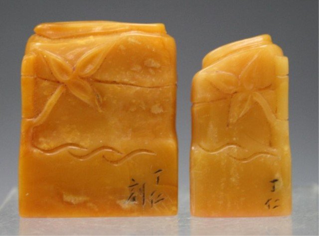 Chinese Set of 2 Carved Tianhuang Stone Seals: Set of two carved seals with custom box, tianhuang stone, China; marked. Dimensions: Smaller 1-1/2"H x 7/8"W x 1/2"D; larger 1-5/8"H x 1-1/4"W x 1/2"D; box 1-5/8"H x 4-1/2"W x 3"D