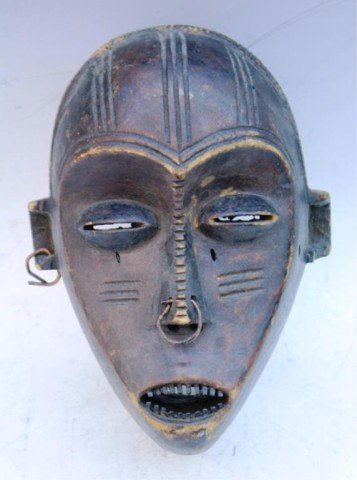 Wooden African Mask with Earring and Nose Ring: Wooden mask with earring and nose ring and incised linear designs; unmarked. Dimensions: 9"H x 6-1/2"W x 5"D