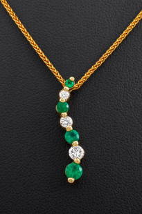 14K Yellow Gold Emerald Diamond Pendant Necklace: 14K yellow gold pendant necklace, brightly polished, featuring 4 prong set round brilliant cut emeralds, weighing a total of approx. 0.32 carat, further adorned with three prong set round brilliant