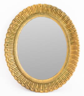 Italian Hollywood Regency Style Gilt Wood Mirror: Italian gilt wood mirror in the Hollywood Regency style with stylized petal design, "MADE IN ITALY" label to reverse. 26.25" H x 22.25" W.