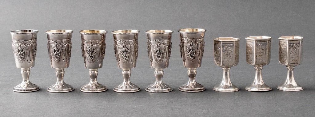Judaica Sterling Silver Wine Cups, 9: Judaica group of nine sterling silver wine cups, all stamped 925, three hexagonal, three tapering, and each decorated with grapes and floral ornamentation. Weight: 5.53 ozt.; 3.2" H x 1.5" diameter. P