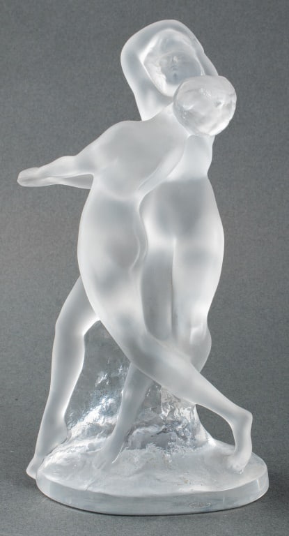 Lalique France "Deux Danseuses" Crystal Sculpture: Lalique France "Deux Danseuses" [Two Dancers] crystal glass sculptural figurine, depicting two nude women in a dance, marked "Lalique / France" to base. 10" H x 5" W x 3.25" D.