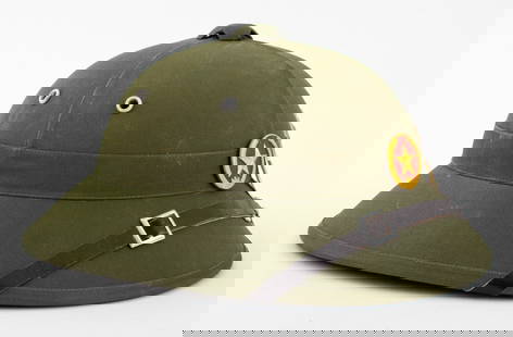 North Vietnamese Military Helmet: North Vietnamese army militaria helmet, with paper label. 6.5" H x 10.5" W x 12.25" D. Provenance: From the collection of Le Lieu and Malcolm Browne (American, 1931-2012), the photojournalist who took