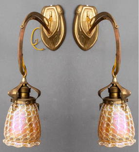 Art Nouveau Gilt Bronze & Quezal Glass Sconces, 2: Pair of Art Nouveau gilt bronze one arm wall sconces with stylized foliate design and Quezal art glass shades in iridescent gold-tone hues, shades marked. 18" H x 11" W x 4" D. Provenance: From a Rye,