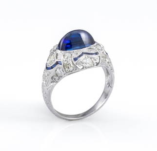 Art Deco Platinum Diamond Blue Sapphire Ring: Art Deco period platinum ring, brightly polished and engraved, featuring centered bezel set blue sapphire high dome oval cabochon, weighing approx. 3.30 carats, further adorned with 22 old European