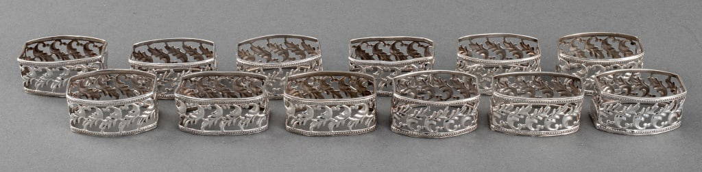 Buccellati Sterling Silver Napkin Ring Holders, 12: Set of twelve Buccellati sterling silver napkin ring holders with pierced foliate design, each marked "Buccellati / ITALY / 925" to side. Weight: 10.08 ozt.; 2.25" L x 1.5" W x 1.25" D.