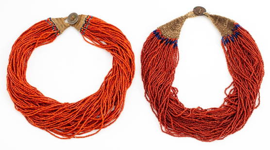 Indian Naga Multi-Strand Coral Beaded Necklaces, 2: Group jewelry lot of two vintage Indian, Nagaland, multi-strand torsade style necklaces, one with cylindrical coral beads and round blue glass accents, one with round coral and cobalt blue glass beads