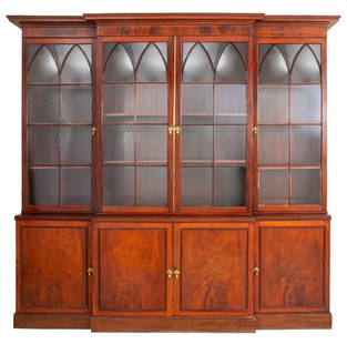 George III Mahogany Breakfront Bookcase, ca. 1815: George III mahogany breakfront bookcase, circa 1815 or later, with molded cornice and frieze above a rectangular break front, the four brass-mounted glazed doors with Gothick ogee mullions opening to