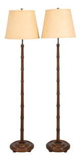 Faux Bamboo Floor Lamps, Pair: Pair of Faux Bamboo floor lamps or torcheres, each with tall support in the manner of a sectioned bamboo column above a circular molded base. 60" H x 10" diameter.