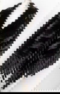 Christian Dior Chevron Mink Fur Cape: Christian Dior black mink chevron-pieced mink, the furs aligned in reverse herringbone pattern, the edges sewn with tails, lined in black silk, and with label to interior reading "Paris / Christian Di