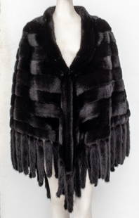 Christian Dior Chevron Mink Fur Cape: Christian Dior black mink chevron-pieced mink, the furs aligned in reverse herringbone pattern, the edges sewn with tails, lined in black silk, and with label to interior reading "Paris / Christian Di