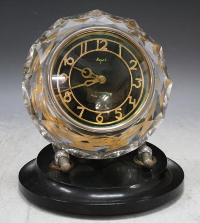 Deco Soviet Russian Majak Desk Clock: Cut glass desk clock mounted on black base, Majak, 11 Jewels, Made in USSR; marked. Dimensions: 7-1/2"H x 6-3/4"W x 6-1/2"