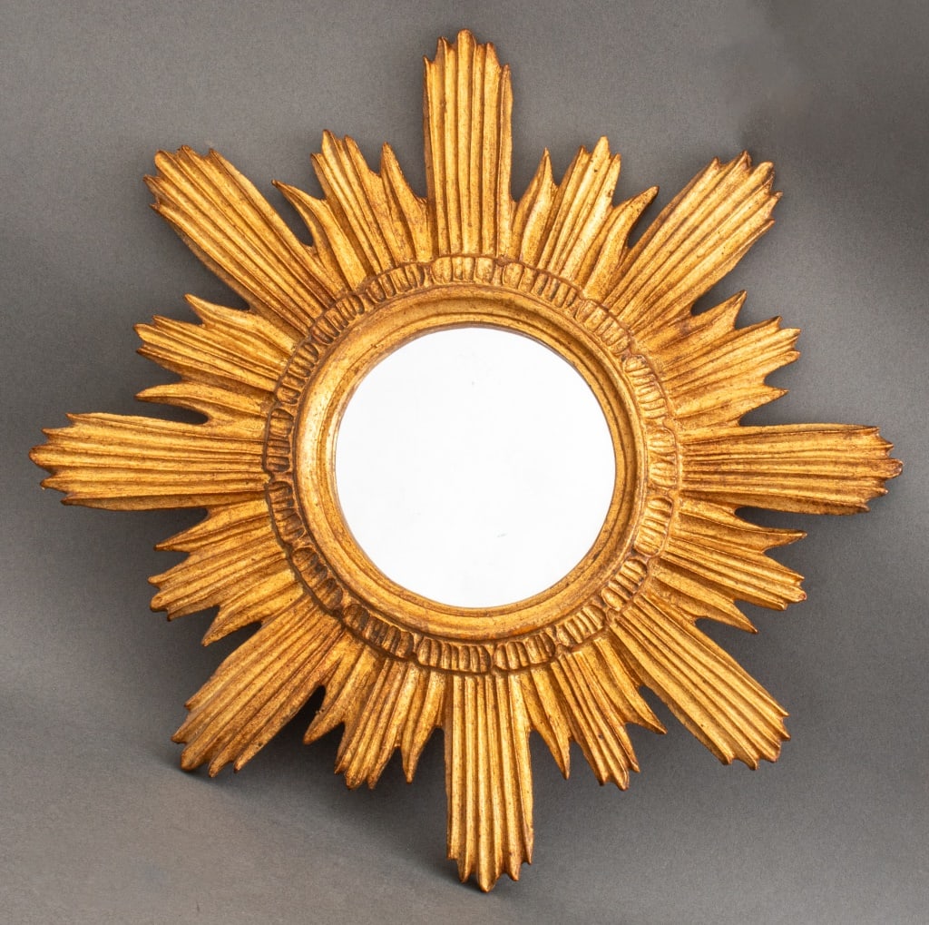 Gilt Wood Starburst Mirror: Gilt wood mirror in the form of the sun or a star burst. Looking glass: 5.75" diameter; frame: 18" diameter,