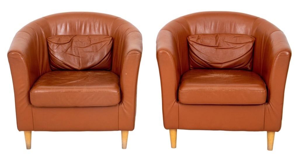 Scandinavian Club Chairs, Pair: Pair of Scandinavian club chairs, each with leather upholstery (worn), curved back and arms above a drop in cushion on four tapering columnar legs. 29" H x 30" W x 31" D; seat: 16.5" H.