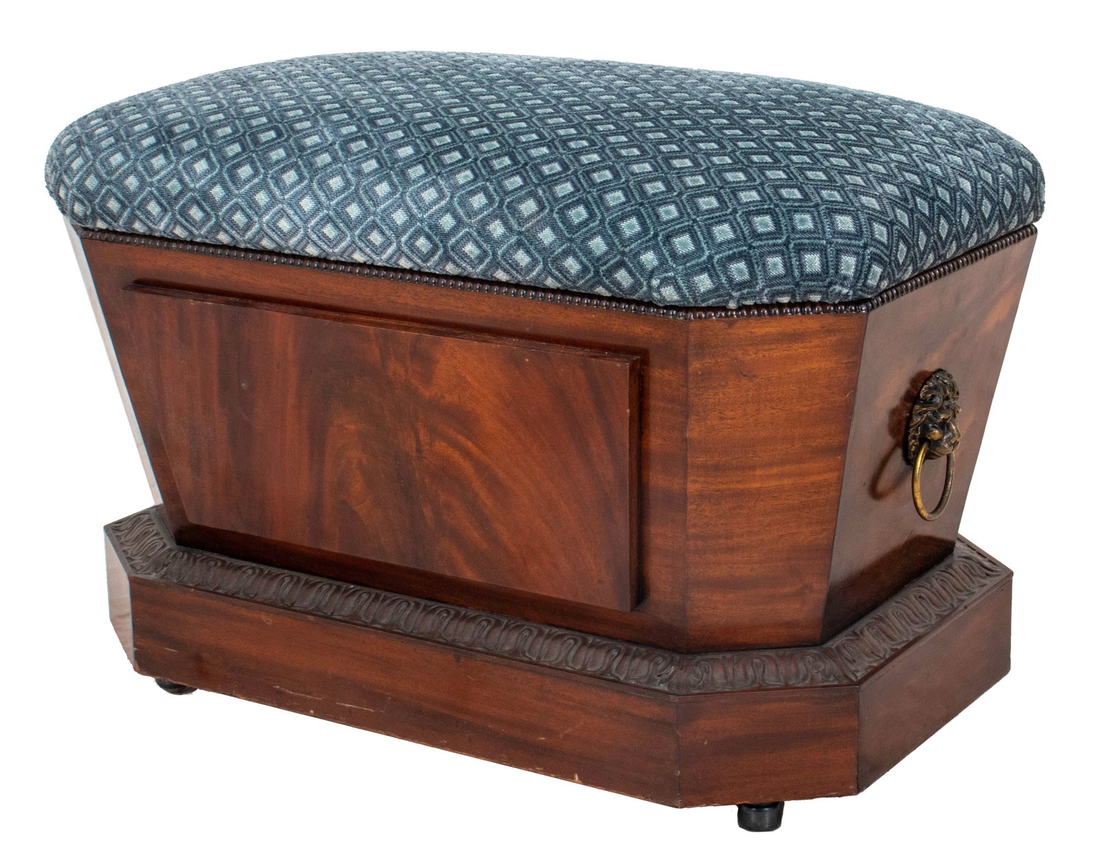 Regency Mahogany Cellarette Mounted as a Bench: Regency mahogany cellarette of tapering hexagonal form, the sides mounted with lion's head ring handles, on an egg and dart carved base above conforming plinth, the lid upholstered as a bench in blue 