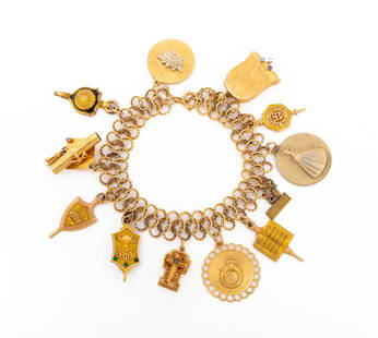 Vintage 14K Yellow Gold Charm Bracelet: Vintage 14K Yellow Gold Charm Bracelet, decorated with six 14K yellow gold charms, four 10K yellow gold charms, and two gold plate on base metal charms, marked: "14K 10K". Measuring approx. 7 1/2" x 1