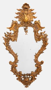 Italian Belle Epoque Venetian Rococo Style Mirror: Italian Belle Epoque Venetian Rococo Mirror, 19th Century, likely Turin, with elaborate carved rococo style surround with traces of gilding, the cornice centering a peacock, the attribute of the godde