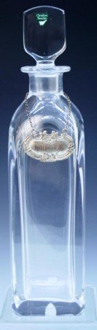 Swedish Orrefors Glass Bourbon Decanter: Square glass decanter, metal plaque hangs around neck of bottle with Bourbon in repousse, Orrefors, Sweden; marked. Dimensions: 12-1/8"H x 3"W x 3"D