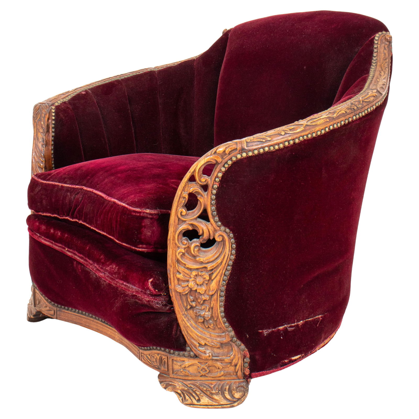 Art Deco Red Velvet Upholstered Club Chair: Art Deco Red Velvet Upholstered Club Shell Chair enhanced with heavily carved wood arms and base, circa 1930s. 32" H x 37" W x 36" D; seat: 17" H. Keywords: Furniture, Seating, Lounge chair, Art Deco