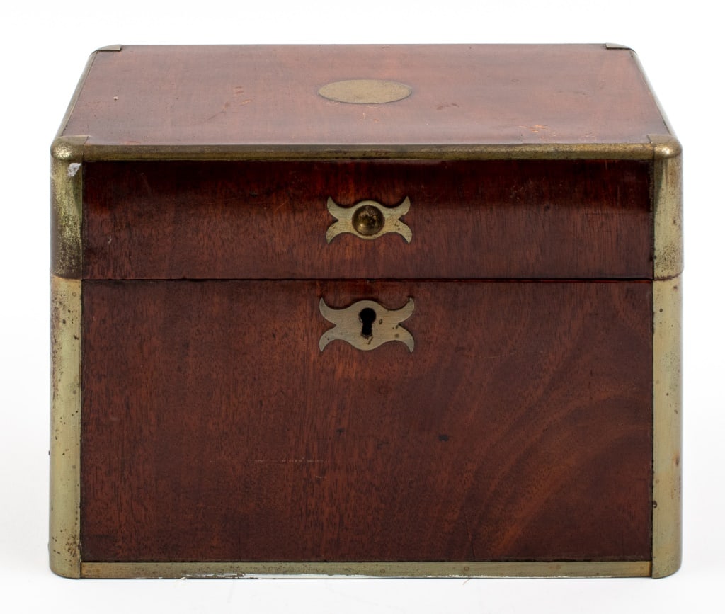 Victorian Mahogany Casket Box, 19th Century: English Victorian Mahogany Casket Box, enhanced with brass edges, interior covered with red fabric, circa early nineteenth century. 7.5" H x 10.75" W x 6.5" D. Keywords: British, Antique, Desk accesso