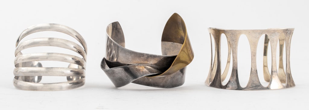Modern Sterling Silver Cuff Bracelets, 3: Group of Three Modern Sterling Silver Cuff Bracelets comprising one with five connecting lines, marked "BELL STERLING" inside, one geometric design bracelet with elongated ovoid spaces, marked "925" i