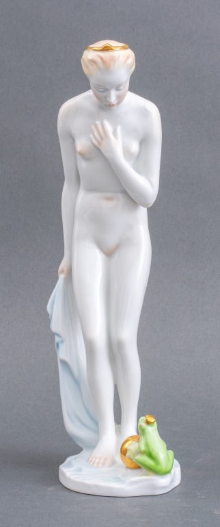 Herend Nude Frog Princess Porcelain Figurine: Herend Frog Princess Porcelain Figurine, of a nude woman gazing down at the frog prince who rescued her golden ball, marked with the Herend maker's mark. Previous repair to base. 11" H x 3.25" Diamete
