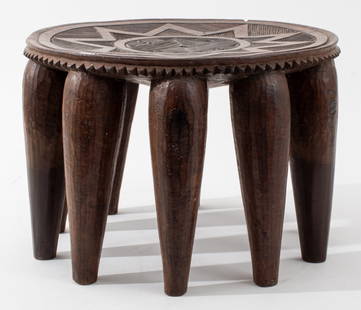 Nigerian Nupe Carved Wood Stool: Nigerian Nupe Carved Wood Stool, featuring stylized sun motif, upon ten legs. 9" H x 12.75" Diameter. Provenance: From a Christopher Street collection. Keywords: African art, Relief carving, Geometric