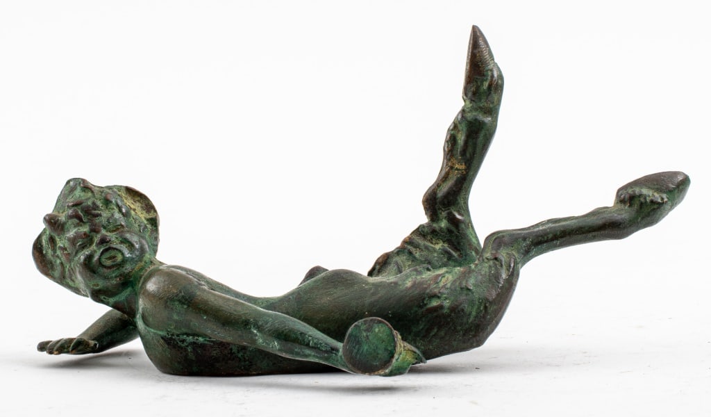 Patinated Bronze Reclining Satyr Statuette: Patinated and Verdigris Bronze Statuette, depicting a satyr or fawn laying on his stomach and holding a cup in his outstretched left hand. 2.75" H x 6" W x 3" D. Provenance: From a Manhattan collector
