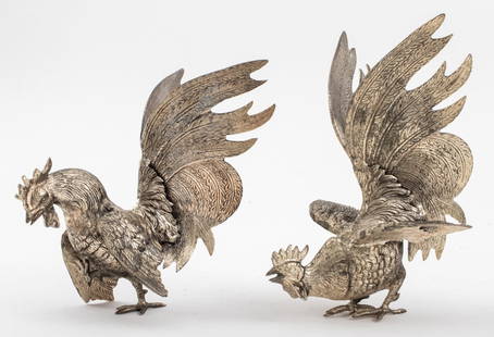 Silver-Tone Metal Fighting Cock Figures, 2: Two Silver-Tone Metal Fighting Cock Rooster Figure Sculptures, the birds' tail feathers and wings outstretched, one with a raised claw. Taller: 8.75" H x 6.5" W x 6" D. Provenance: Property from the M