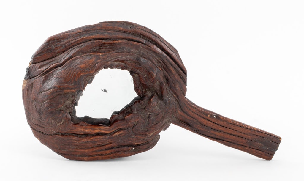 Carved Wood Hand Mirror: Carved Wood Hand Mirror of tree knot with hammered metal backing. 16.50" L x 9.25" W. Provenance: From a Manhattan collector. Keywords: Handmade, Interior Design, Carved wood