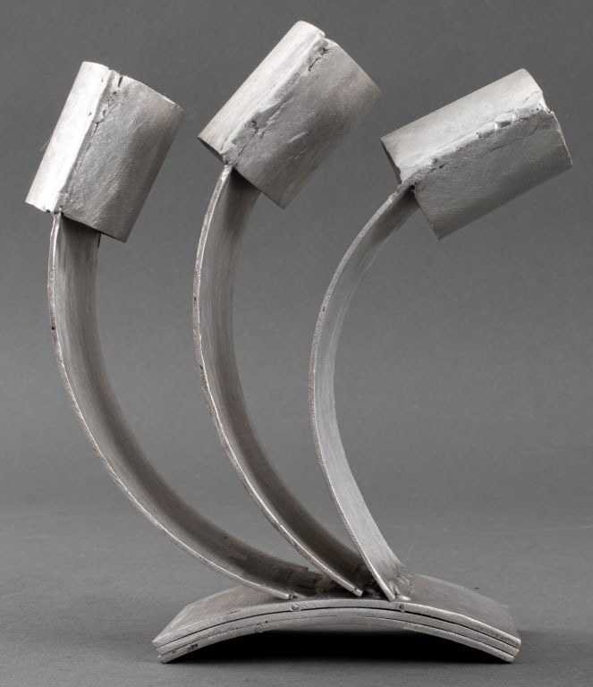Paula Meizner "Shin" Judaica Aluminum Sculpture: Paula Meizner (American, born Poland, 1904-1990) "Shin" Modernist Judaica aluminum metal sculpture depicting the Hebrew character with three branches aflame. 8" H x 6" W x 3" D. Provenance: From the e