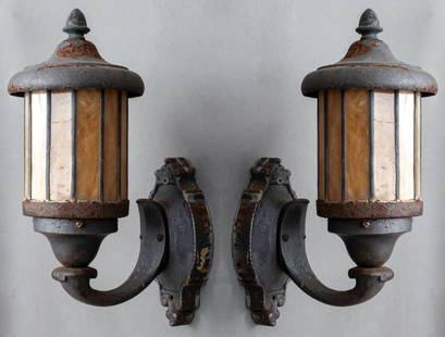 Aesthetic Movement Iron Slag Glass Sconces, Pair: Pair of Aesthetic Movement Cast Iron Outdoor Wall Sconce Lanterns, Circa 20th Century, with marbled amber orange and white slag glass shades. 16" H x 6" W x 9" D. Provenance: From a Rye, N.Y. collecti