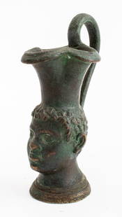 Grand Tour Verdigris Patinated Bronze Head Jug: Grand Tour Verdigris Patinated Bronze Head Jug, trefoil spout. 4.5" H x 2.5" W x 1.5" D. Provenance: From a Manhattan collector. Keywords: Etruscan Revival, Pitcher, Ewer, Diminutive, Oinochoe, Antiqu