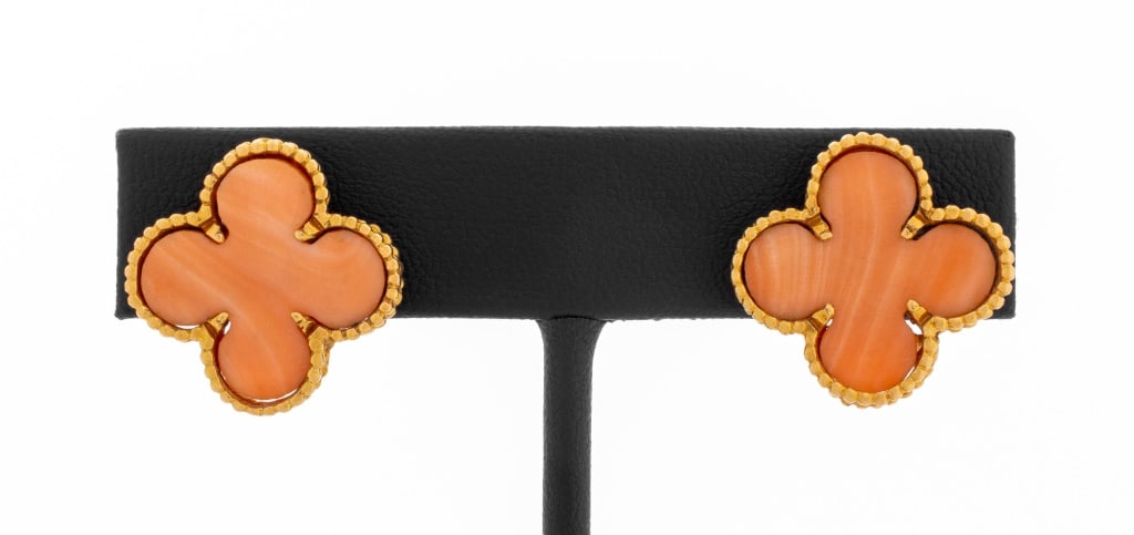 18K Pink Coral Alhambra Style Clip Earrings: 18K Yellow Gold Alhambra Style Clip Earrings, featuring pink coral motifs, worn as clip on earlobes with pads and omega backs. Marked: "750". Measuring approx. 3/4" x 3/4"", 4.1 dwt. Provenance: From 