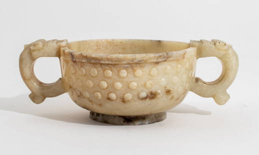 Chinese Archaic Carved Jade Qilin 2-Handled Cup: Chinese Archaic Carved White Jade Qilin Form Double Handled Cup, with russet brown veining raised on round foot. 1.75" H x 5" W x 3" D. Provenance: From a New York City collection. Keywords: Asian