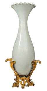 Ormolu Mounted Japanese Porcelain Palace Vase: Belle Epoque Ormolu-Mounted Japanese Porcelain Palace Vase, in monochromatic white glazed porcelain, of elongated trumpet form with ruffled flaring rim above a long neck, the mount in the Louis XV